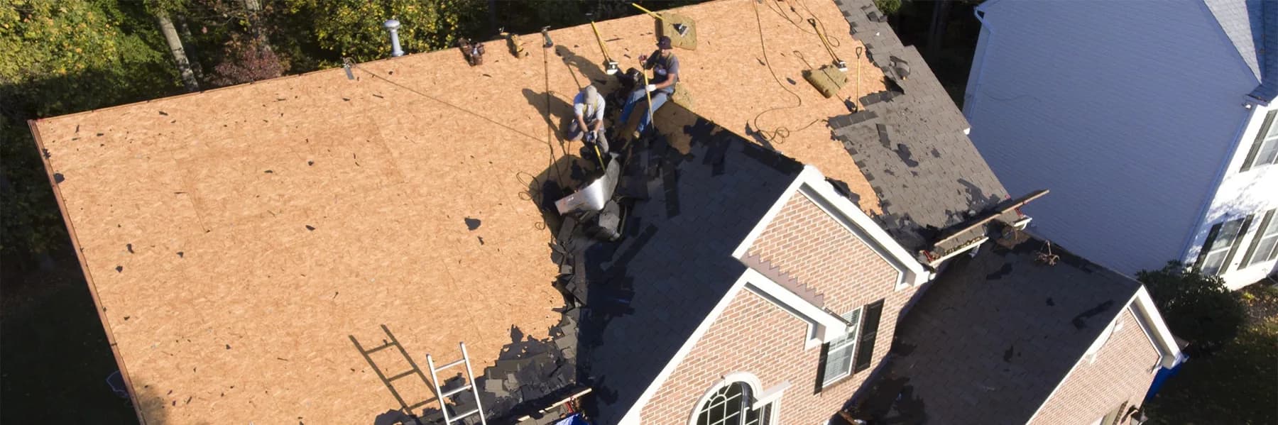 Aerial photo of Rebuilt Roofing crew during a shingle tear-off in Leawood, Kansas