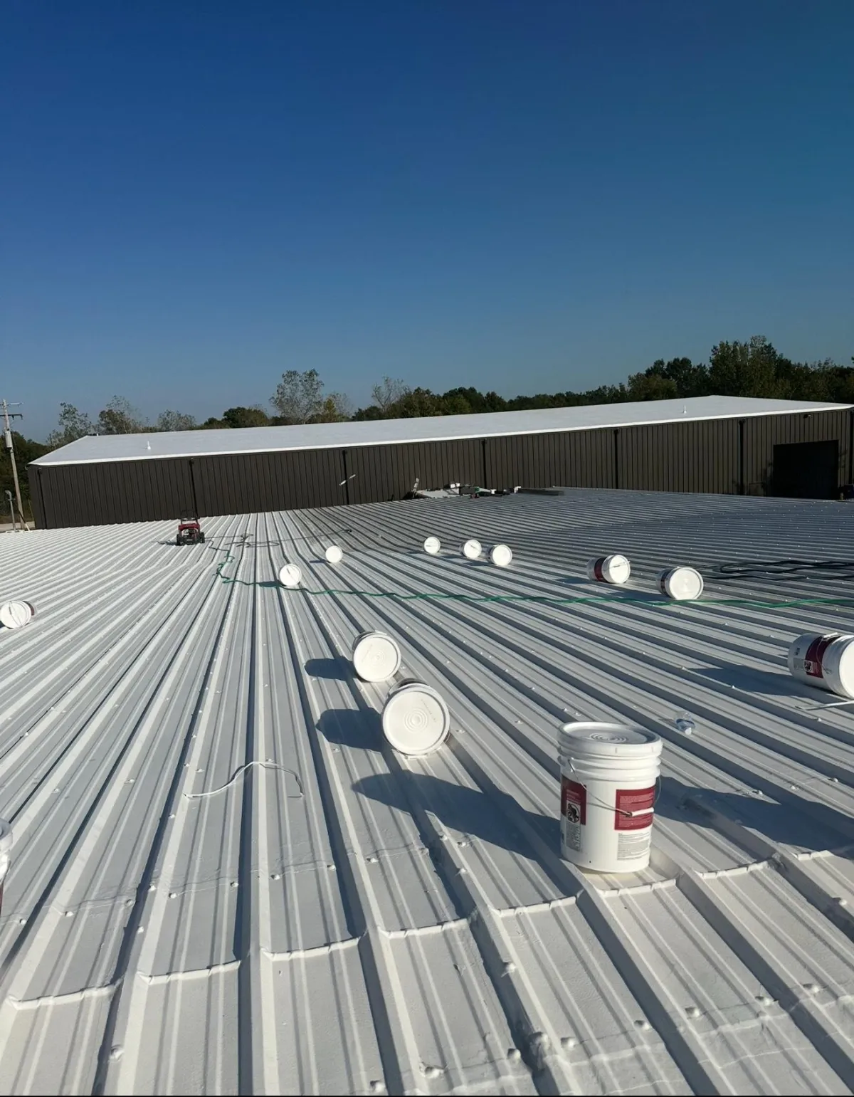 Rebuilt Roofing crew on a commercial roof project in Merriam, Kansas